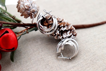 Brincos em ouro com (20) diamantes em talhe brilhante, entrelaçados lisos e fecho omega.