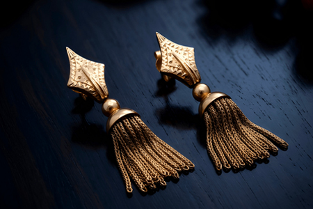 Brincos em ouro em forma de nós com pingentes articulados.