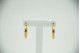 Brincos em forma de argolas de ouro amarelo com faixas relevadas.