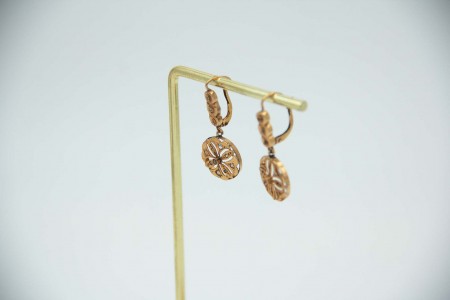 Brincos de ouro amarelo circulares com recortes, articulados e aplicações.