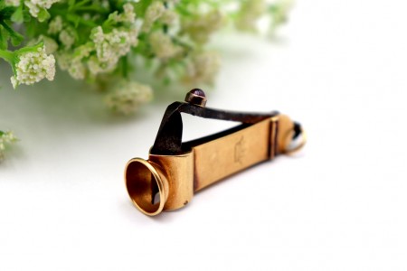 Corta cigarrilhas vintage em ouro com aplicações de rubis e argola de suspensão