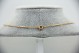  Gargantilha em ouro amarelo com diamantes (13) em talhe brilhante 8/8 e granada