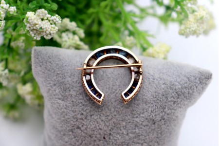 Pregadeira em ouro em forma de ferradura com diamantes coroados e safiras 