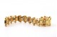 Pulseira em ouro de forma arliculada com lascas de diamantes e par bolas em cada