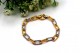 Pulseira em ouro bicolor com elos alternados e relevados.