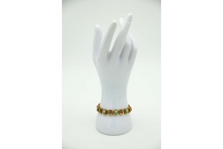 Pulseira articulada em ouro amarelo com flores em cada elo, esmaltes em cada elo