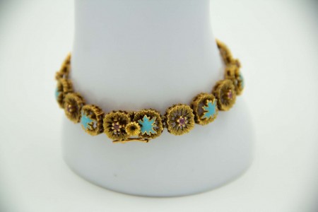 Pulseira articulada em ouro amarelo com flores em cada elo, esmaltes em cada elo