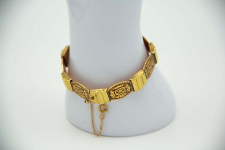 Pulseira poliarticulada em ouro bicolor e elementos simétricos relevados