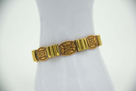 Pulseira poliarticulada em ouro bicolor e elementos simétricos relevados