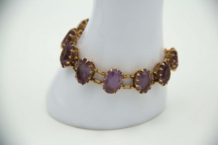 Pulseira de ouro amarelo poliarticulada com pedras roxas