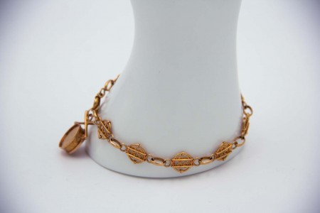 Pulseira de ouro articulada com elos circulares ao estilo de filgrana.