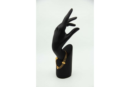 Pulseira de ouro amarelo com relevos e elos articulados.
