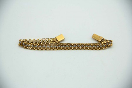 Pulseira articulada em ouro amarelo com pérolas e corrente de segurança