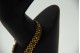 Pulseira de ouro amarelo articulada com turquezas, pérolas e rubis.