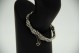 Pulseira de ouro branco articulado com elos em forma de flores com quatro pérola