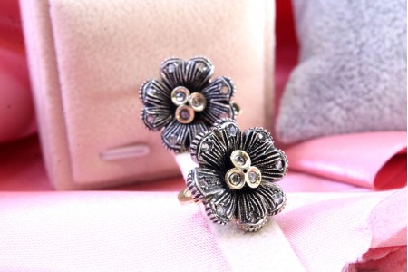 Par de brincos em ouro e prata com lascas de diamante em forma de flor.