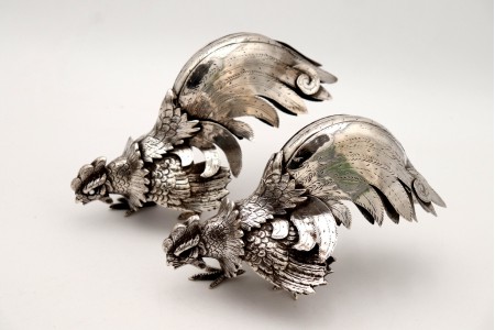 Conjunto de galos de luta em prata com relevos e aplicações em vulto perfeito.