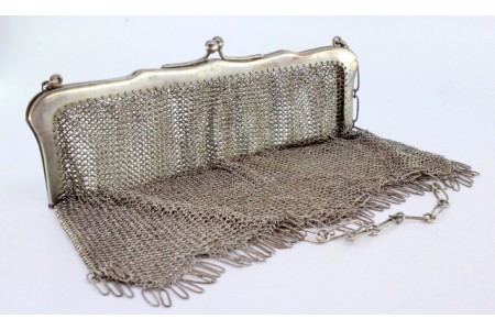 Bolsa de mão em prata com arco liso e franjas em suspensão, corrente em malha cadeado.