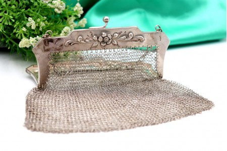 Bolsa em malha de prata com relevos florais no arco e corrente em malha cadeado