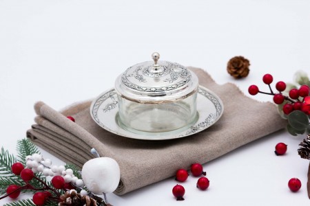 Bomboneira de prata e vidro com pires e relevos alusivos a flores.