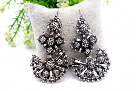 Brincos em prata com relevos, aplicações e bombolinas oscilantes.