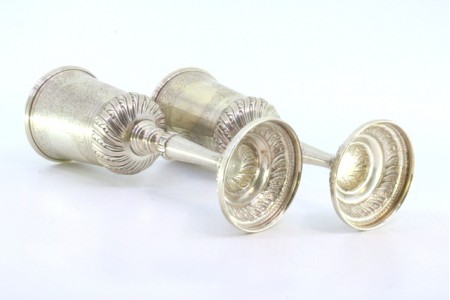 Par de cálices em prata com gravados e frisos relevados nas bases circulares.