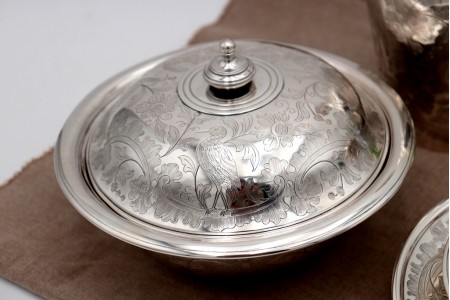 Conjunto de quatro peças em prata com relevos florais e animais