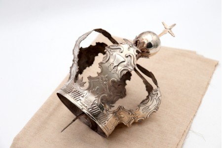 Coroa Mariana em prata alusiva à Virgem com relevos de folhas de acanto, palmetas e recortes, pomo encimado com urbe e cruz.