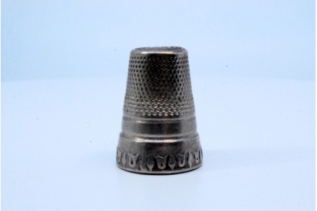 Dedal em prata com pequenos relevos. 