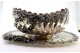  Fruteira em prata com aplicações de motivos florais relevados, frisos concheados, corpo espiralado e assente em base lisa de forma elíptica.