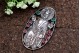 Moldura em prata com figura religiosa e pedras coloridas incrustadas