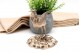 Paliteiro de prata em forma de ave com motivos florais relevados 