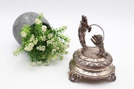 Paliteiro de prata com palhaço domador e leão em salto de corda