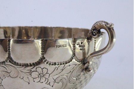 Taça em prata gomada com motivos florais gravados e asas vazadas.