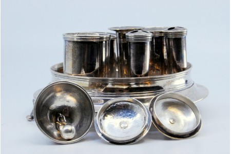 Tinteiro em prata com dois depósitos, campainha, dois suportes para caneta e assente numa base com três pés em forma de concha.