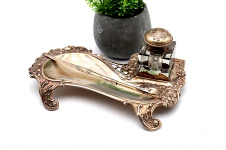 Tinteiro em prata com um deposito em vidro, caneta e assente em quatro pés recor