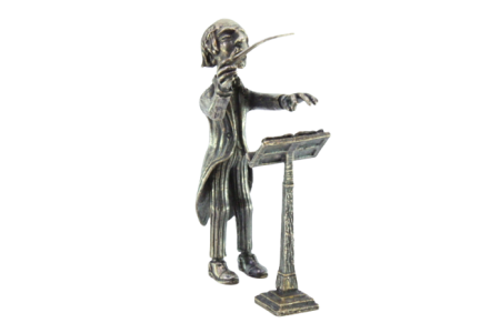 Figura de maestro em prata com batuta e pauta.