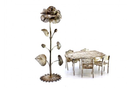 Conjunto de peças em prata de filigrana, mesa, cadeiras e roseira trepadeira.