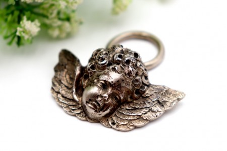 Anjo da Guarda em prata revelada em vulto perfeito com argola de suspensão.